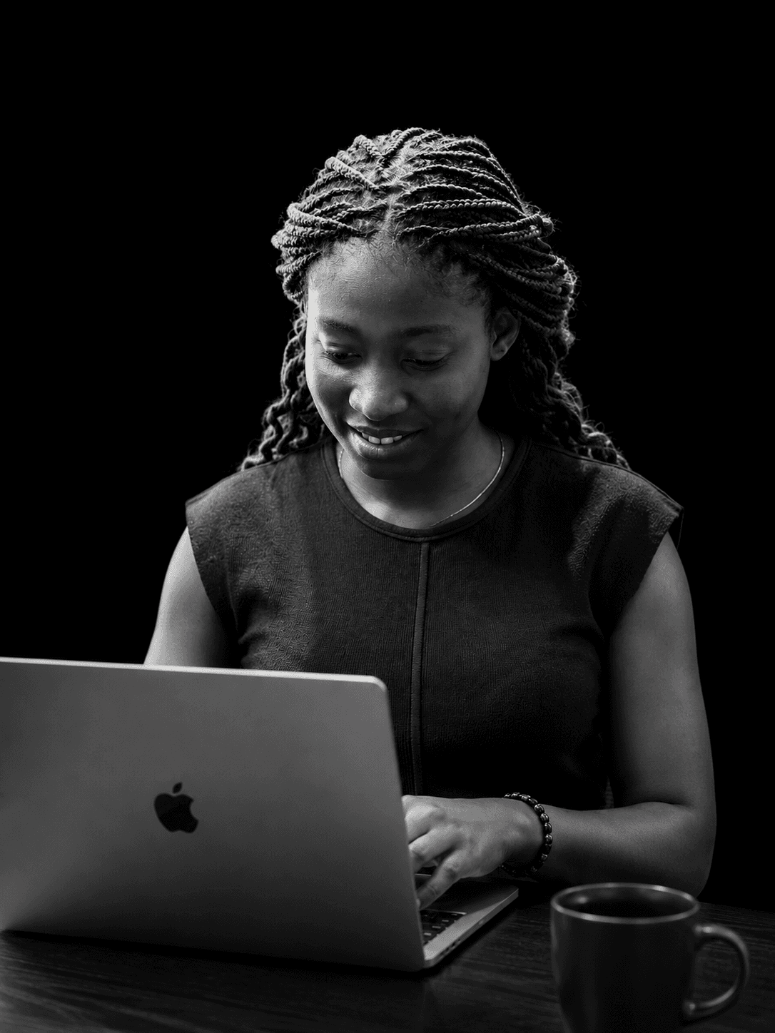 Etuk Godsgift working on a laptop